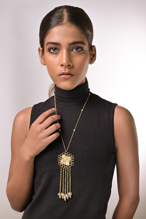 Women wearing brass pendant