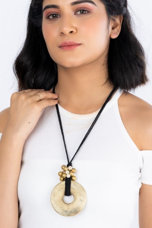 Women wearing dokra pendant necklace